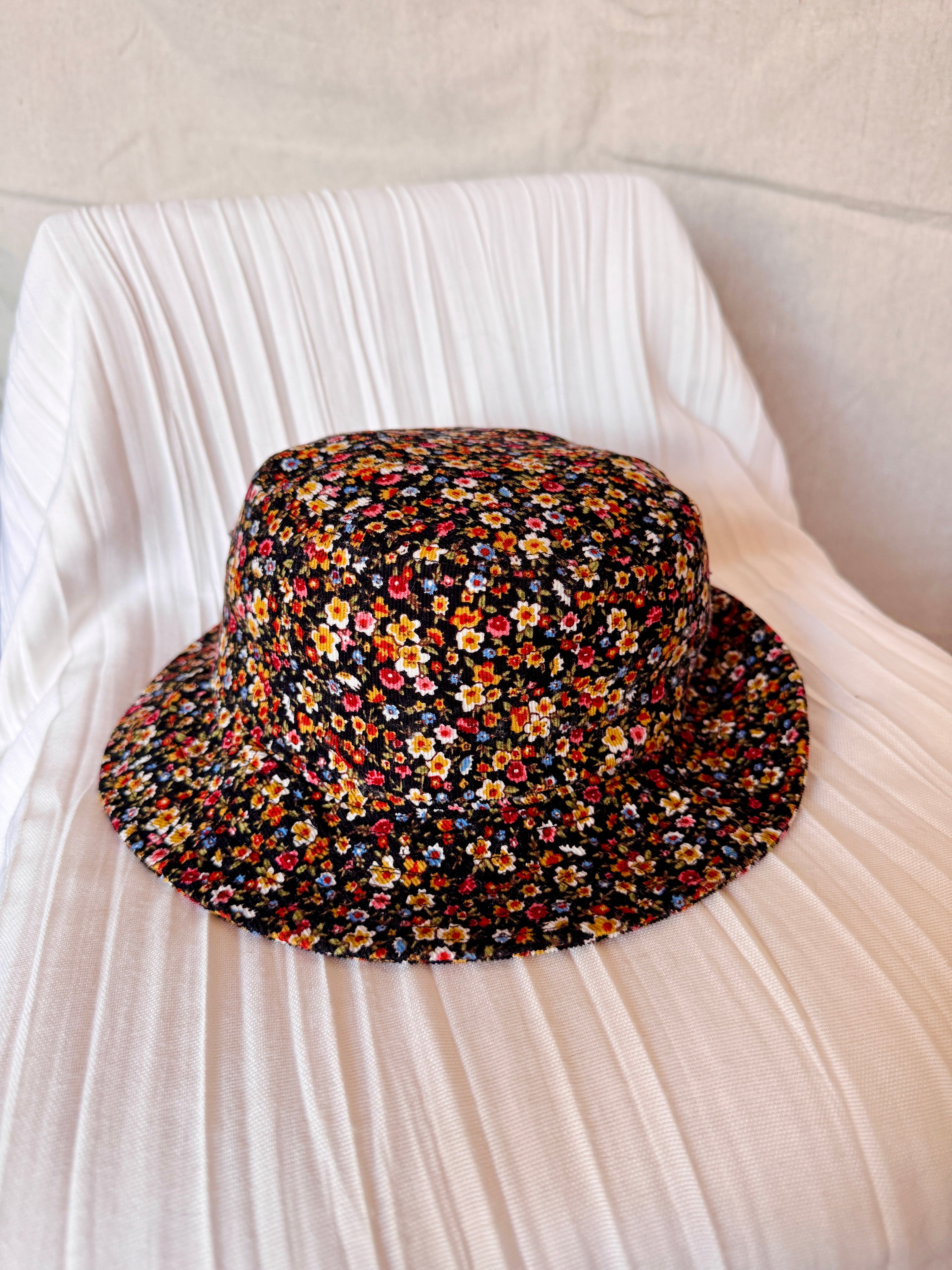 Floral patterned bucket hat on a white fabric background