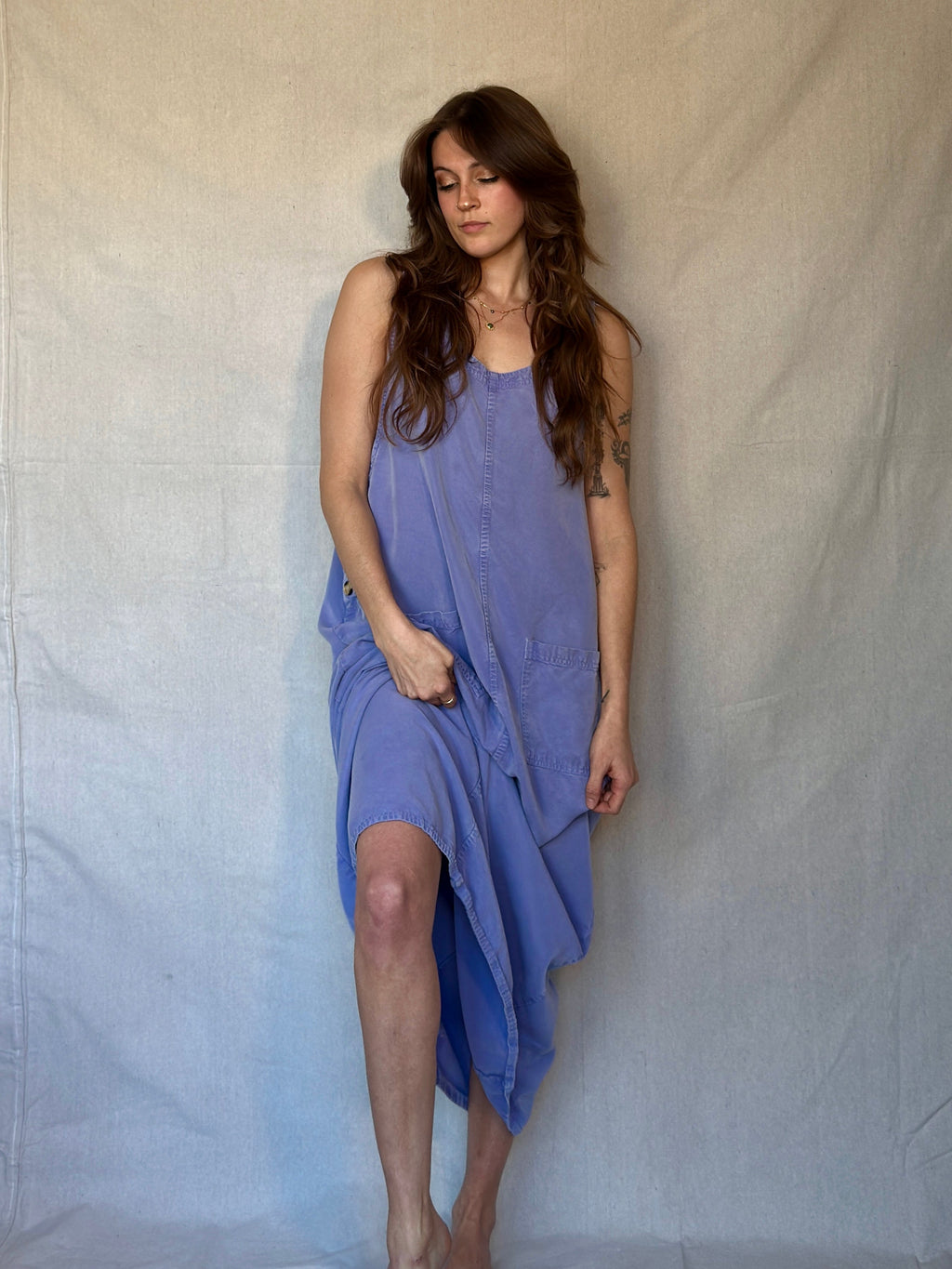 Woman wearing a purple dress against a plain background